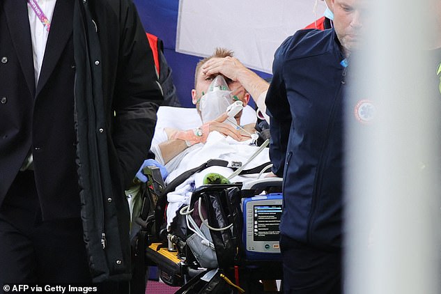 52614827-10374973-Eriksen_is_taken_off_the_pitch_to_an_ambulance_after_being_reviv-a-12_1641480589147.jpg